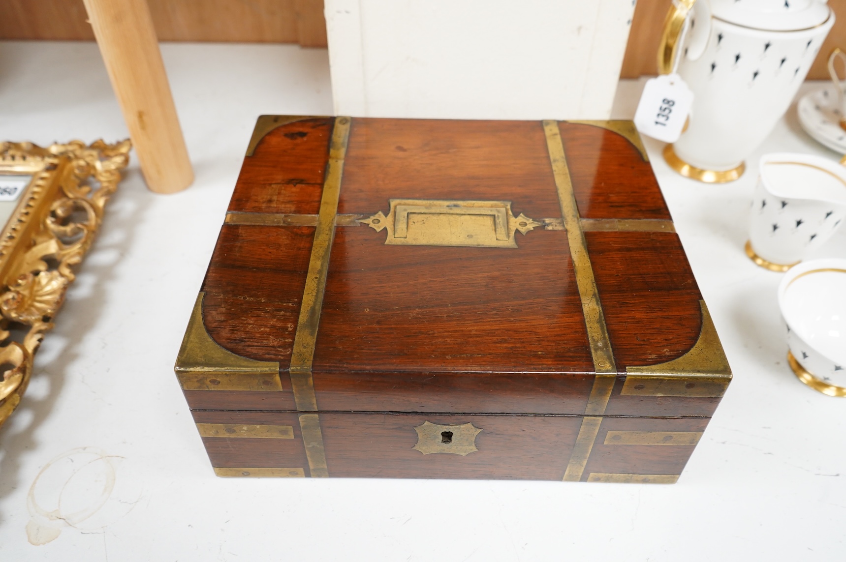 A George IV mahogany and brass bound campaign vanity box with original fittings, 27cm wide x 23cm deep x 10cm high